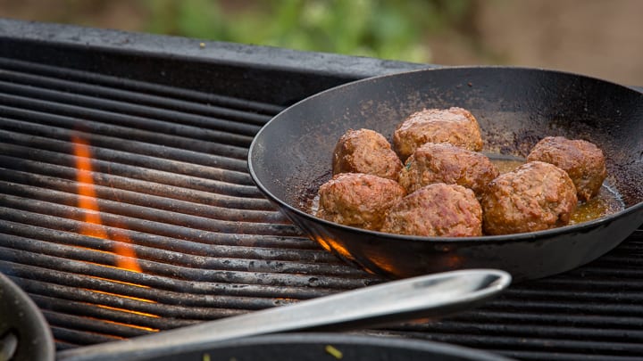 Pan-roasted lamb meatballs on the grill roasting in a steel pan