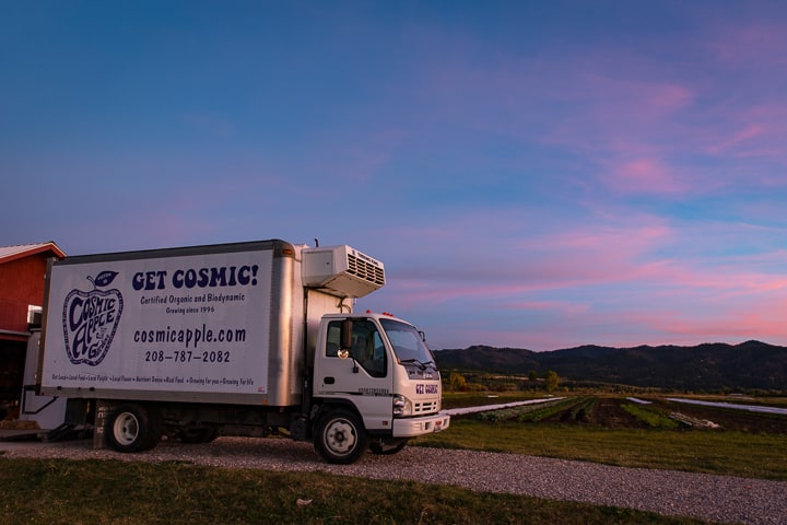 Cosmic Apple Gardens refrigerator truck at sunset with fields in the backgound