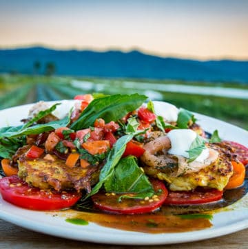 Crispy on the outside and custardy on the inside, these pan-fried summer squash fritters are the creation of Dale Sharkey of Cosmic Apple Gardens. Served hot with peppery arugula and a juicy tomato and basil salad, embellished with gravlax and crème fraîche.