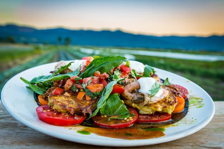 Crispy on the outside and custardy on the inside, these pan-fried summer squash fritters are the creation of Dale Sharkey of Cosmic Apple Gardens. Served hot with peppery arugula and a juicy tomato and basil salad, embellished with gravlax and crème fraîche. 