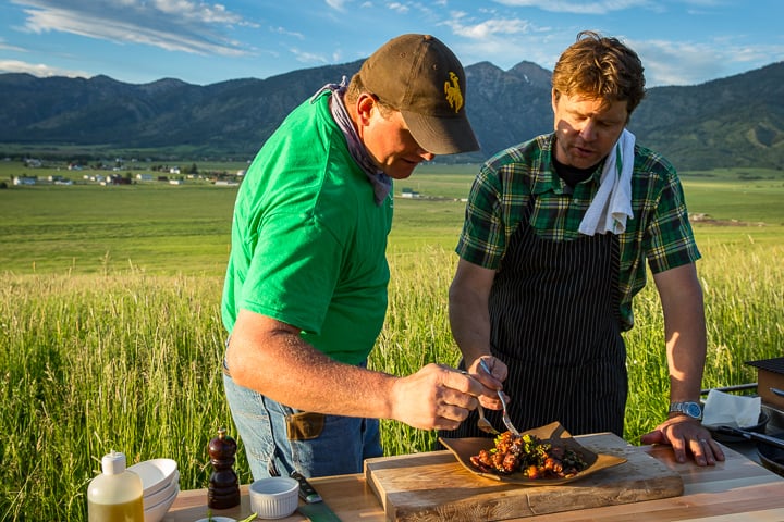 Marion Robinson and Eric Wilson tasting the crispy pork belly outside on the ranch