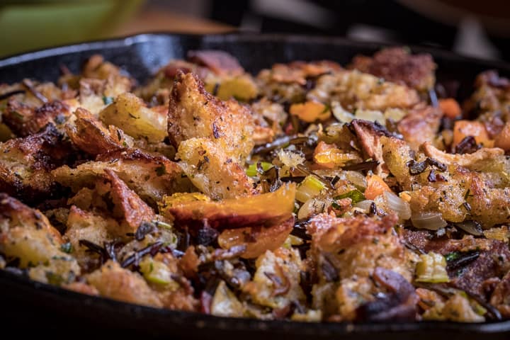 Close up look at the Wood Fired Sourdough Stuffing in a cast iron on a table