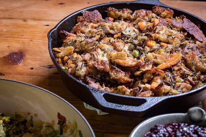 Wood Fired Sourdough Stuffing in a cast iron on a table next to other dishes