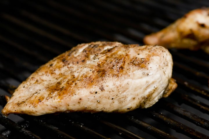 Grilling a chicken breast for the Backcountry Curry Chicken Salad.